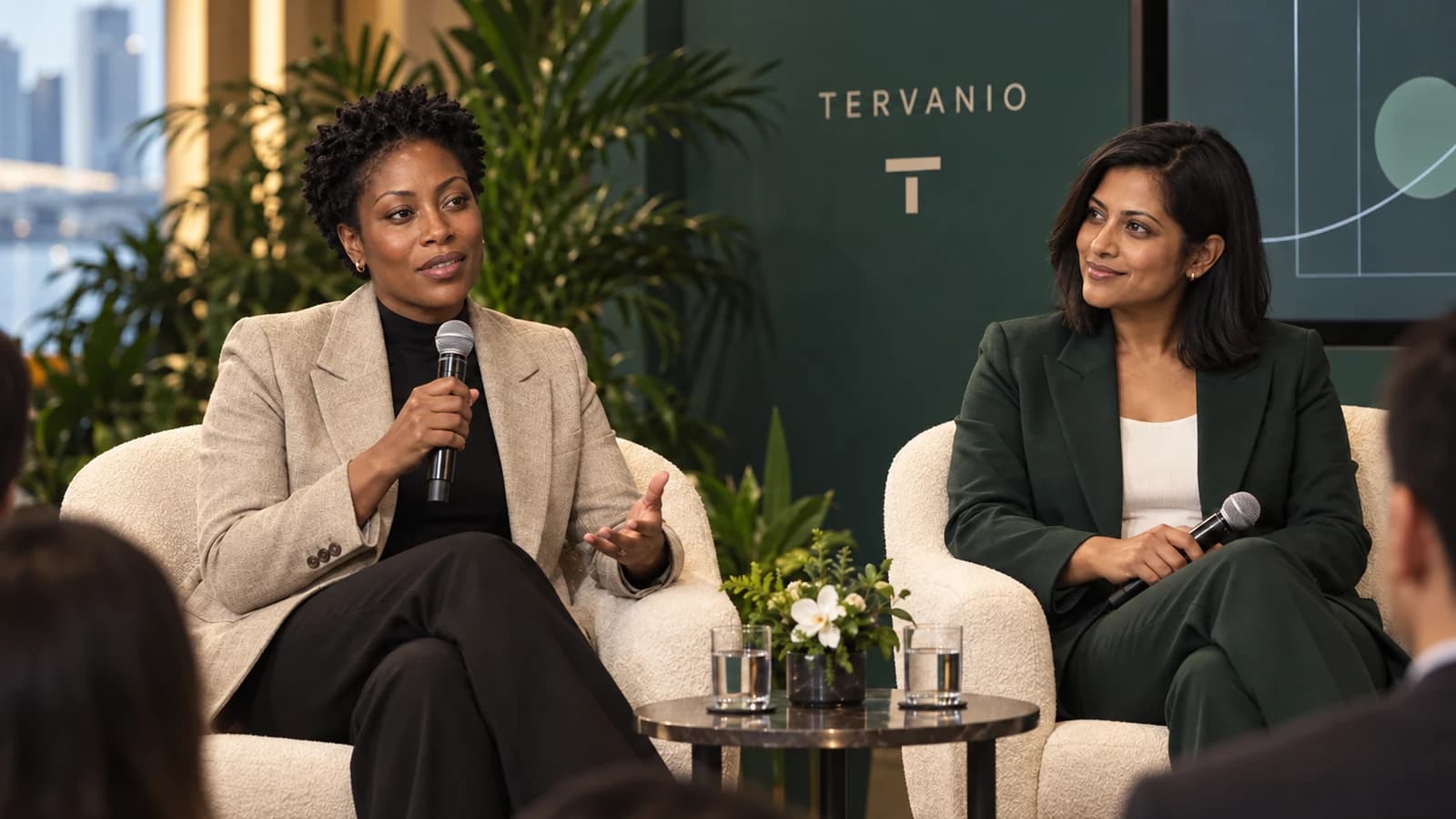 Celia Darnell and Maya Renford discussing payment infrastructure from two chairs on a panel in Singapore.