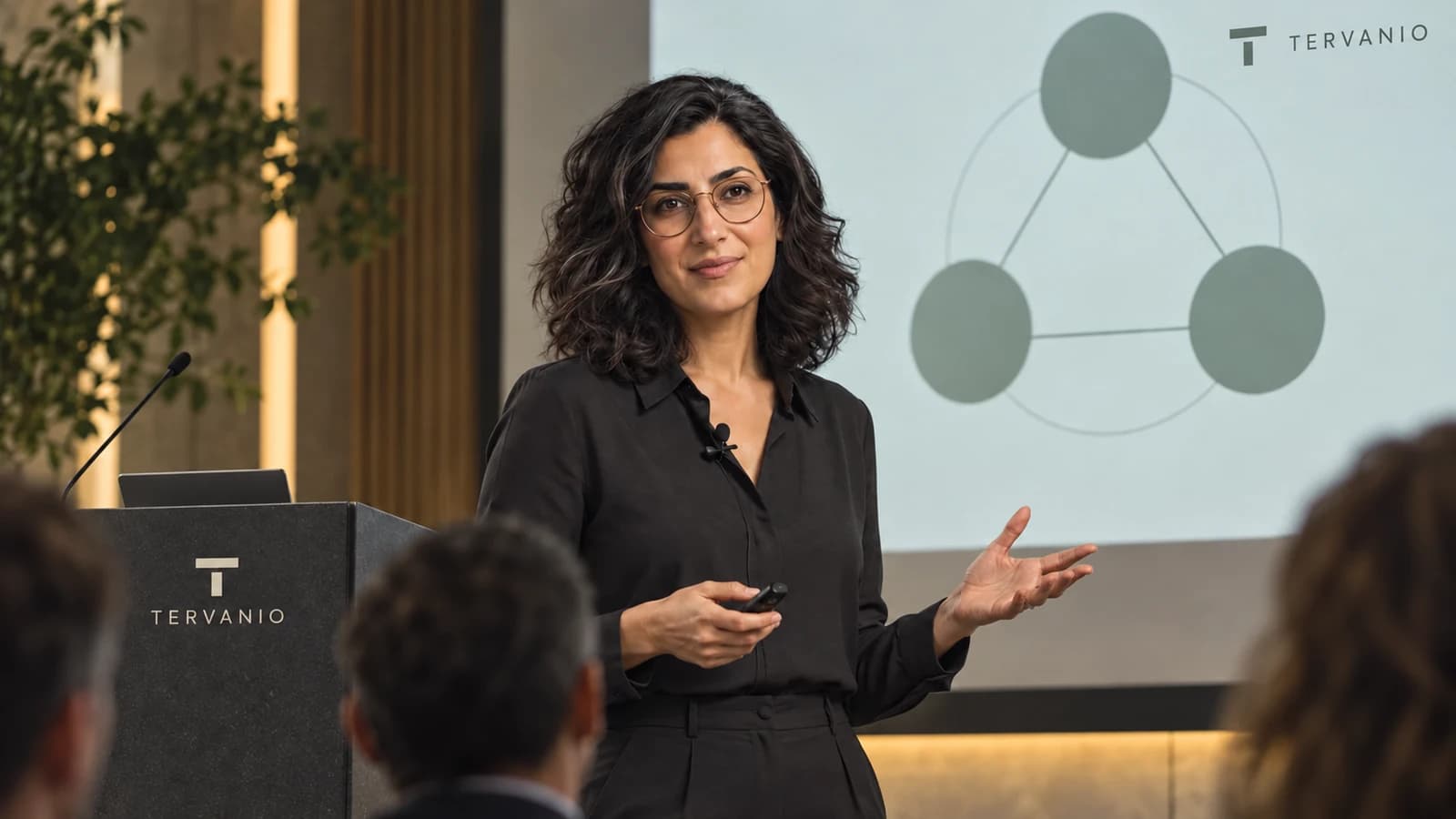 Mira Solven giving a technical presentation with a simple diagram onstage in Amsterdam.